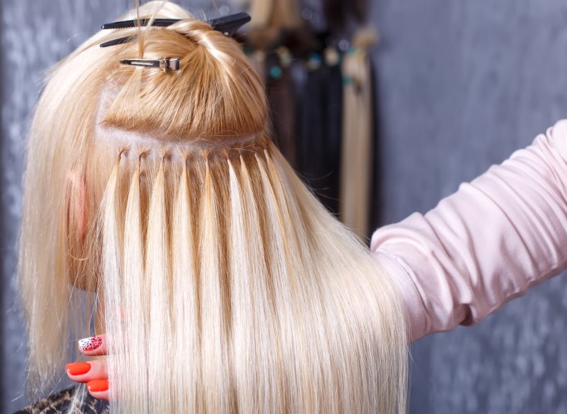 hair-extensions-procedure-hairdresser-does-hair-extensions-to-young-girl-blonde-in-a-beauty-salon.jpg