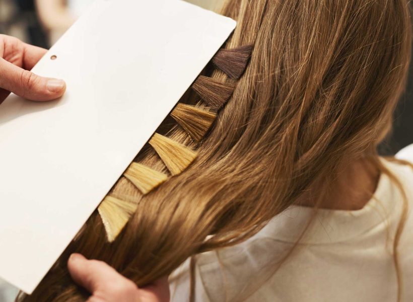 stylist-choosing-color-from-hair-samples-for-woman-in-salon-2.jpg
